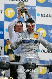29.10.2006 Hockenheim, Germany,  Hans-Jürgen Mattheis (GER), Team Manager HWA, gives Bruno Spengler (CDN), AMG-Mercedes, Portrait (1st) a champaign shower - DTM 2006 at Hockenheimring (Deutsche Tourenwagen Masters)