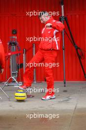 27.01.2006 Barcelona, Spain,  A Scuderia Ferrari mechanic plays football in the pitlane - Formula One Testing, Circuit de Catalunya
