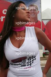 20.10.2006 Sao Paulo, Brazil,  A girl kisses the air towards a picture of Michael Schumacher (GER), Scuderia Ferrari in the background - Formula 1 World Championship, Rd 18, Brazilian Grand Prix, Friday