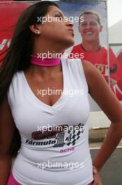 20.10.2006 Sao Paulo, Brazil,  A girl kisses the air towards a picture of Michael Schumacher (GER), Scuderia Ferrari in the background - Formula 1 World Championship, Rd 18, Brazilian Grand Prix, Friday