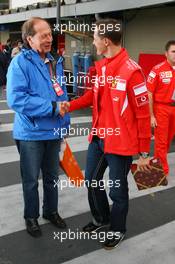 20.10.2006 Sao Paulo, Brazil,  Michael Schumacher (GER), Scuderia Ferrari, receives a gift from a journalist - Formula 1 World Championship, Rd 18, Brazilian Grand Prix, Friday