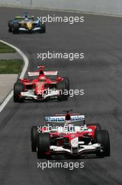 25.06.2006 Montreal, Canada,  Jarno Trulli (ITA), Toyota Racing, TF106 leads Michael Schumacher (GER), Scuderia Ferrari, 248 F1 - Formula 1 World Championship, Rd 9, Canadian Grand Prix, Sunday Race