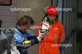 01.10.2006 Shanghai, China,  A renault mechanic holds a broken bottle of champagne - Formula 1 World Championship, Rd 16, Chinese Grand Prix, Sunday Podium