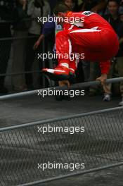 01.10.2006 Shanghai, China,  Michael Schumacher (GER), Scuderia Ferrari, jumps the barrier to celebrate with the team - Formula 1 World Championship, Rd 16, Chinese Grand Prix, Sunday Podium