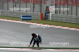 01.10.2006 Shanghai, China,  A marshall picks up some debris from the circuit - Formula 1 World Championship, Rd 16, Chinese Grand Prix, Sunday Race