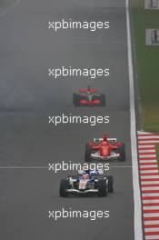 01.10.2006 Shanghai, China,  Rubens Barrichello (BRA), Honda Racing F1 Team, RA106  and Michael Schumacher (GER), Scuderia Ferrari, 248 F1 - Formula 1 World Championship, Rd 16, Chinese Grand Prix, Sunday Race
