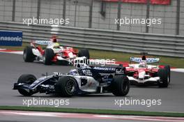01.10.2006 Shanghai, China,  Nico Rosberg (GER), WilliamsF1 Team leads Jarno Trulli (ITA), Toyota Racing - Formula 1 World Championship, Rd 16, Chinese Grand Prix, Sunday Race