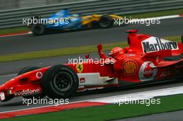 01.10.2006 Shanghai, China,  Michael Schumacher (GER), Scuderia Ferrari, 248 F1 and Giancarlo Fisichella (ITA), Renault F1 Team, R26 - Formula 1 World Championship, Rd 16, Chinese Grand Prix, Sunday Race