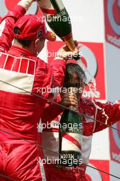 07.05.2006 Nürburg, Germany,  Michael Schumacher (GER), Scuderia Ferrari Marlboro, Portrait (1st), spraying champaign over Felipe Massa (BRA), Scuderia Ferrari Marlboro, Portrait (3rd) - Formula 1 World Championship, Rd 5, European Grand Prix, Sunday Podium