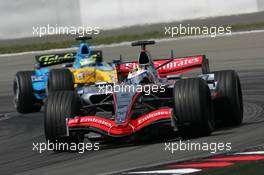 07.05.2006 Nürburg, Germany,  Juan-Pablo Montoya (COL), McLaren Mercedes MP4-21, leads Giancarlo Fisichella (ITA), Mild Seven Renault F1 R26 - Formula 1 World Championship, Rd 5, European Grand Prix, Sunday Race