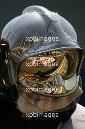 14.07.2006 Magny Cours, France,  Franck Montagny (FRA), Super Aguri F1, Reflection in a Fire Marshalls helmet - Formula 1 World Championship, Rd 11, French Grand Prix, Friday Practice