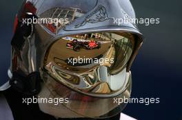 14.07.2006 Magny Cours, France,  Neel Jani (SUI), Test Driver, Scuderia Toro Rosso, STR01, Reflection in a Fire Marshalls helmet - Formula 1 World Championship, Rd 11, French Grand Prix, Friday Practice