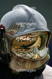 14.07.2006 Magny Cours, France,  Jenson Button (GBR), Honda Racing F1 Team, RA106 Reflection in a Fire Marshalls helmet - Formula 1 World Championship, Rd 11, French Grand Prix, Friday Practice