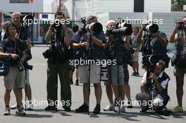 14.07.2006 Magny Cours, France,  Photographers in the paddock - Formula 1 World Championship, Rd 11, French Grand Prix, Friday