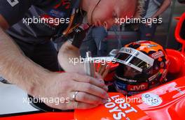 14.07.2006 Magny Cours, France,  Christijan Albers (NED), Midland F1 Racing M16, adjusting his mirrors with a mechanic - Formula 1 World Championship, Rd 11, French Grand Prix, Friday Practice