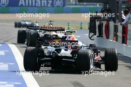 14.07.2006 Magny Cours, France,  Cars driving out of the pitbox at the start of the session - Formula 1 World Championship, Rd 11, French Grand Prix, Friday Practice