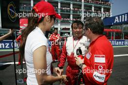 16.07.2006 Magny Cours, France,  Michelle Yeoh (MLY, ex. James Bond girl, actor) Girlfriend of Jean Todt, with Jean Todt (FRA), Scuderia Ferrari, Teamchief, General Manager, Team Principal and Hisao Suganuma (JPN), Bridgestone technical manager - Formula 1 World Championship, Rd 11, French Grand Prix, Sunday Pre-Race Grid