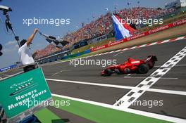 16.07.2006 Magny Cours, France,  Race winner Michael Schumacher (GER), Scuderia Ferrari 248 F1, taking the chequered flag - Formula 1 World Championship, Rd 11, French Grand Prix, Sunday Podium