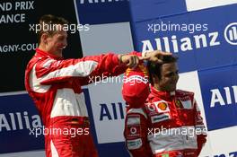 16.07.2006 Magny Cours, France,  Michael Schumacher (GER), Scuderia Ferrari, Portrait (1st, left) and Felipe Massa (BRA), Scuderia Ferrari, Portrait (3rd, right) - Formula 1 World Championship, Rd 11, French Grand Prix, Sunday Podium