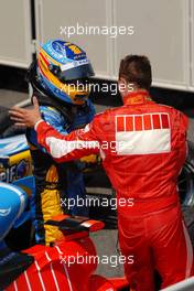 16.07.2006 Magny Cours, France,  Fernando Alonso (ESP), Renault F1 Team (2nd, left), congratulates race winner Michael Schumacher (GER), Scuderia Ferrari (1st, right) - Formula 1 World Championship, Rd 11, French Grand Prix, Sunday Podium