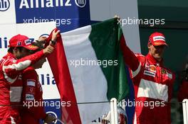 16.07.2006 Magny Cours, France,  Michael Schumacher (GER), Scuderia Ferrari, Portrait (1st, right) and Felipe Massa (BRA), Scuderia Ferrari, Portrait (3rd, left) and Nicolas Todt (FRA), Team Manager ART Grand Prix, holding up the Italian flag - Formula 1 World Championship, Rd 11, French Grand Prix, Sunday Podium