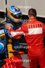 16.07.2006 Magny Cours, France,  Fernando Alonso (ESP), Renault F1 Team (2nd, left), congratulates race winner Michael Schumacher (GER), Scuderia Ferrari (1st, right) - Formula 1 World Championship, Rd 11, French Grand Prix, Sunday Podium