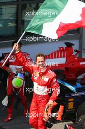 16.07.2006 Magny Cours, France,  1st place, Michael Schumacher (GER), Scuderia Ferrari with the Italian flag - Formula 1 World Championship, Rd 11, French Grand Prix, Sunday Podium