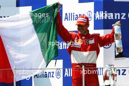 16.07.2006 Magny Cours, France,  Michael Schumacher (GER), Scuderia Ferrari, with the Italian flag - Formula 1 World Championship, Rd 11, French Grand Prix, Sunday Podium