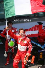 16.07.2006 Magny Cours, France,  1st place, Michael Schumacher (GER), Scuderia Ferrari with the Italian flag - Formula 1 World Championship, Rd 11, French Grand Prix, Sunday Podium