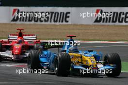 16.07.2006 Magny Cours, France,  Fernando Alonso (ESP), Renault F1 Team, R26 leads Michael Schumacher (GER), Scuderia Ferrari, 248 F1 - Formula 1 World Championship, Rd 11, French Grand Prix, Sunday Race