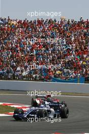 16.07.2006 Magny Cours, France,  Nico Rosberg (GER), WilliamsF1 Team, FW28 Cosworth and Vitantonio Liuzzi (ITA), Scuderia Toro Rosso, STR01 - Formula 1 World Championship, Rd 11, French Grand Prix, Sunday Race