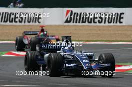 16.07.2006 Magny Cours, France,  Nico Rosberg (GER), WilliamsF1 Team, FW28 Cosworth leads Vitantonio Liuzzi (ITA), Scuderia Toro Rosso, STR01 - Formula 1 World Championship, Rd 11, French Grand Prix, Sunday Race