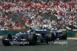 16.07.2006 Magny Cours, France,  Nico Rosberg (GER), WilliamsF1 Team, FW28 Cosworth leads Mark Webber (AUS), Williams F1 Team, FW28 Cosworth - Formula 1 World Championship, Rd 11, French Grand Prix, Sunday Race