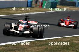 16.07.2006 Magny Cours, France,  Jenson Button (GBR), Honda Racing F1 Team RA106, in front of Felipe Massa (BRA), Scuderia Ferrari 248 F1 - Formula 1 World Championship, Rd 11, French Grand Prix, Sunday Race