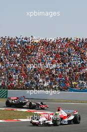 16.07.2006 Magny Cours, France,  Ralf Schumacher (GER), Toyota Racing, TF106 and Kimi Raikkonen (FIN), Räikkönen, McLaren Mercedes, MP4-21  - Formula 1 World Championship, Rd 11, French Grand Prix, Sunday Race