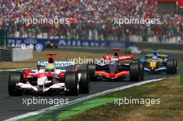 16.07.2006 Magny Cours, France,  Ralf Schumacher (GER), Toyota Racing TF106, leads Kimi Raikkonen (FIN), Team West McLaren Mercedes MP4-21 and Giancarlo Fisichella (ITA), Renault F1 Team R26 - Formula 1 World Championship, Rd 11, French Grand Prix, Sunday Race