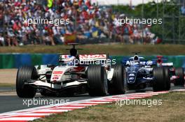 16.07.2006 Magny Cours, France,  Jenson Button (GBR), Honda Racing F1 Team RA106, leads Nico Rosberg (GER), WilliamsF1 Team FW28 and Vitantonio Liuzzi (ITA), Scuderia Toro Rosso STR 01 - Formula 1 World Championship, Rd 11, French Grand Prix, Sunday Race