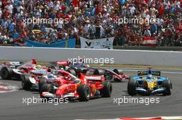 16.07.2006 Magny Cours, France,  Start, Felipe Massa (BRA), Scuderia Ferrari, 248 F1, Fernando Alonso (ESP), Renault F1 Team, R26, Jarno Trulli (ITA), Toyota Racing, TF106 - Formula 1 World Championship, Rd 11, French Grand Prix, Sunday Race