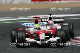 16.07.2006 Magny Cours, France,  Ralf Schumacher (GER), Toyota Racing, TF106 leads Franck Montagny (FRA), Super Aguri F1, Super Aguri F1, SA05 - Formula 1 World Championship, Rd 11, French Grand Prix, Sunday Race