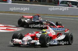 16.07.2006 Magny Cours, France,  Ralf Schumacher (GER), Toyota Racing, TF106 and Kimi Raikkonen (FIN), Räikkönen, McLaren Mercedes, MP4-21 - Formula 1 World Championship, Rd 11, French Grand Prix, Sunday Race