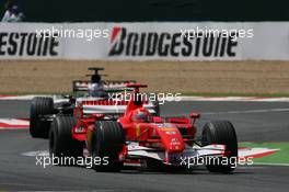 16.07.2006 Magny Cours, France,  Michael Schumacher (GER), Scuderia Ferrari, 248 F1 leads Jenson Button (GBR), Honda Racing F1 Team, RA106 - Formula 1 World Championship, Rd 11, French Grand Prix, Sunday Race