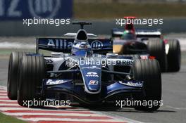 16.07.2006 Magny Cours, France,  Nico Rosberg (GER), WilliamsF1 Team, FW28 Cosworth leads Vitantonio Liuzzi (ITA), Scuderia Toro Rosso, STR01 - Formula 1 World Championship, Rd 11, French Grand Prix, Sunday Race