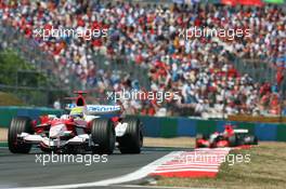 16.07.2006 Magny Cours, France,  Ralf Schumacher (GER), Toyota Racing, TF106 leads Christijan Albers (NED), Midland MF1 Racing, Toyota M16 - Formula 1 World Championship, Rd 11, French Grand Prix, Sunday Race