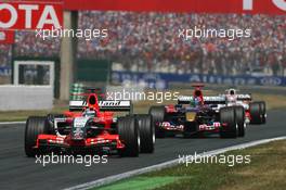 16.07.2006 Magny Cours, France,  Christijan Albers (NED), Midland F1 Racing M16, leads Vitantonio Liuzzi (ITA), Scuderia Toro Rosso STR 01 and Franck Montagny (FRA), Super Aguri F1 SA05 - Formula 1 World Championship, Rd 11, French Grand Prix, Sunday Race