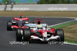 16.07.2006 Magny Cours, France,  Ralf Schumacher (GER), Toyota Racing, TF106 leads Kimi Raikkonen (FIN), Räikkönen, McLaren Mercedes, MP4-21 - Formula 1 World Championship, Rd 11, French Grand Prix, Sunday Race