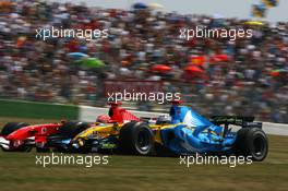 15.07.2006 Magny Cours, France,  Fernando Alonso (ESP), Renault F1 Team R26 and Michael Schumacher (GER), Scuderia Ferrari 248 F1, fighting for position during qualifying - Formula 1 World Championship, Rd 11, French Grand Prix, Saturday Qualifying