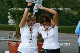 15.07.2006 Magny Cours, France,  Girls from the Red Bull hospitality having fun with some water bottles - Formula 1 World Championship, Rd 11, French Grand Prix, Saturday