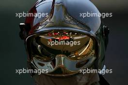 15.07.2006 Magny Cours, France,  Tiago Monteiro (POR), Midland MF1 Racing, Toyota M16 , Reflection in a Fire Marshalls helmet - Formula 1 World Championship, Rd 11, French Grand Prix, Saturday Practice