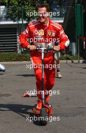 15.07.2006 Magny Cours, France,  Michael Schumacher (GER), Scuderia Ferrari 248 F1, on a small step, with some empty cans hanging behind his step which Bridgestone engineers put behind it - Formula 1 World Championship, Rd 11, French Grand Prix, Saturday