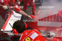 15.07.2006 Magny Cours, France,  Car of Michael Schumacher (GER), Scuderia Ferrari 248 F1, caught fire when returning in the pits - Formula 1 World Championship, Rd 11, French Grand Prix, Saturday Practice